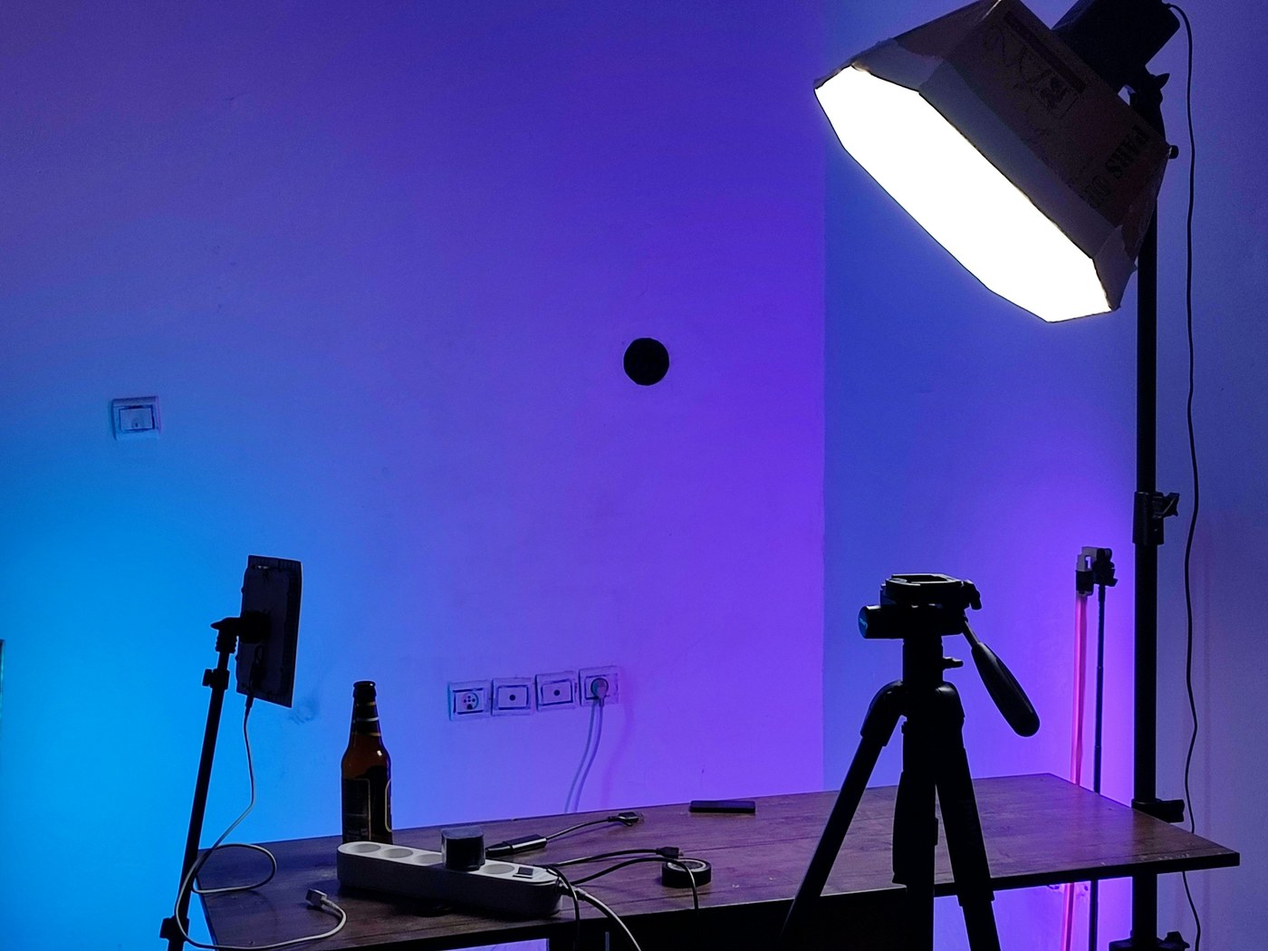 Live-streaming studio equipment under blue and purple neon-style lighting